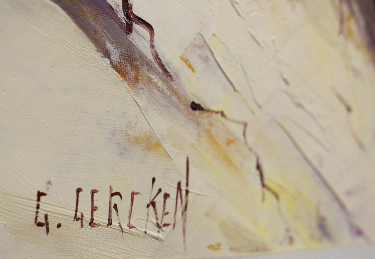 Artistic signature on a textured surface with abstract brushstrokes