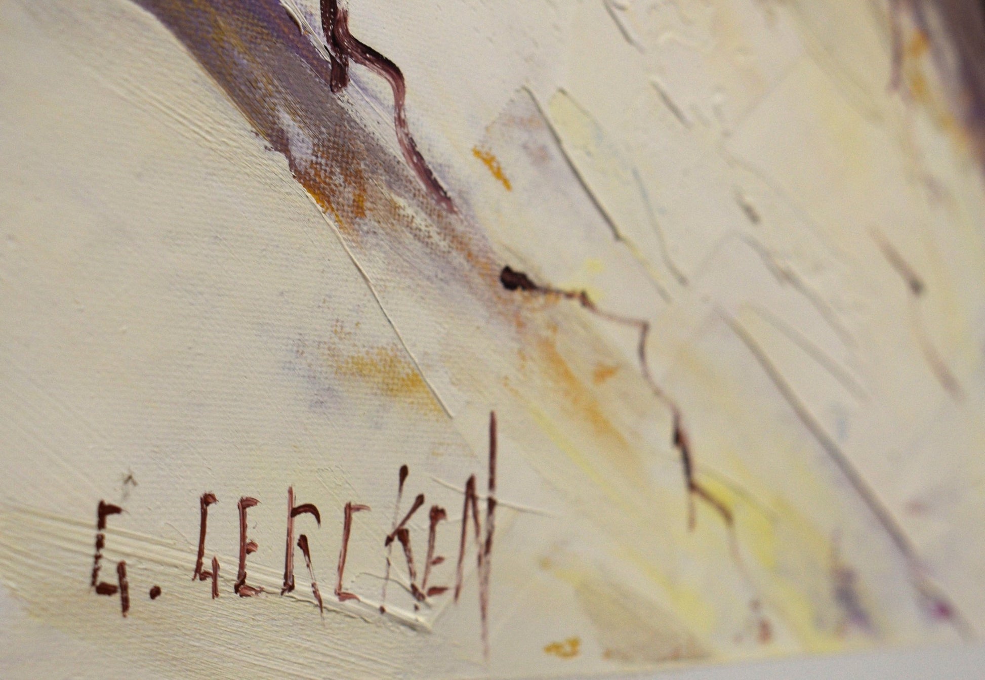 Artistic signature on a textured surface with abstract brushstrokes
