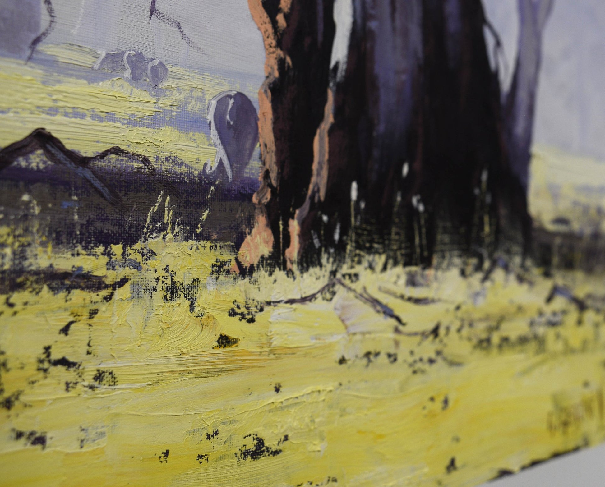 Painting of a horse walking on a yellow field with mountains in the background