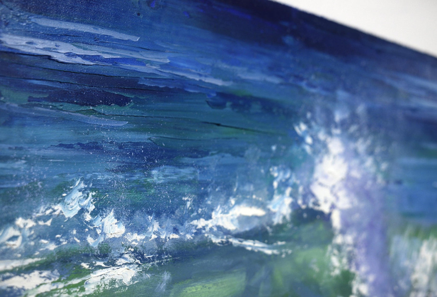 Close-up of a painting of a wave with blue and green colors.