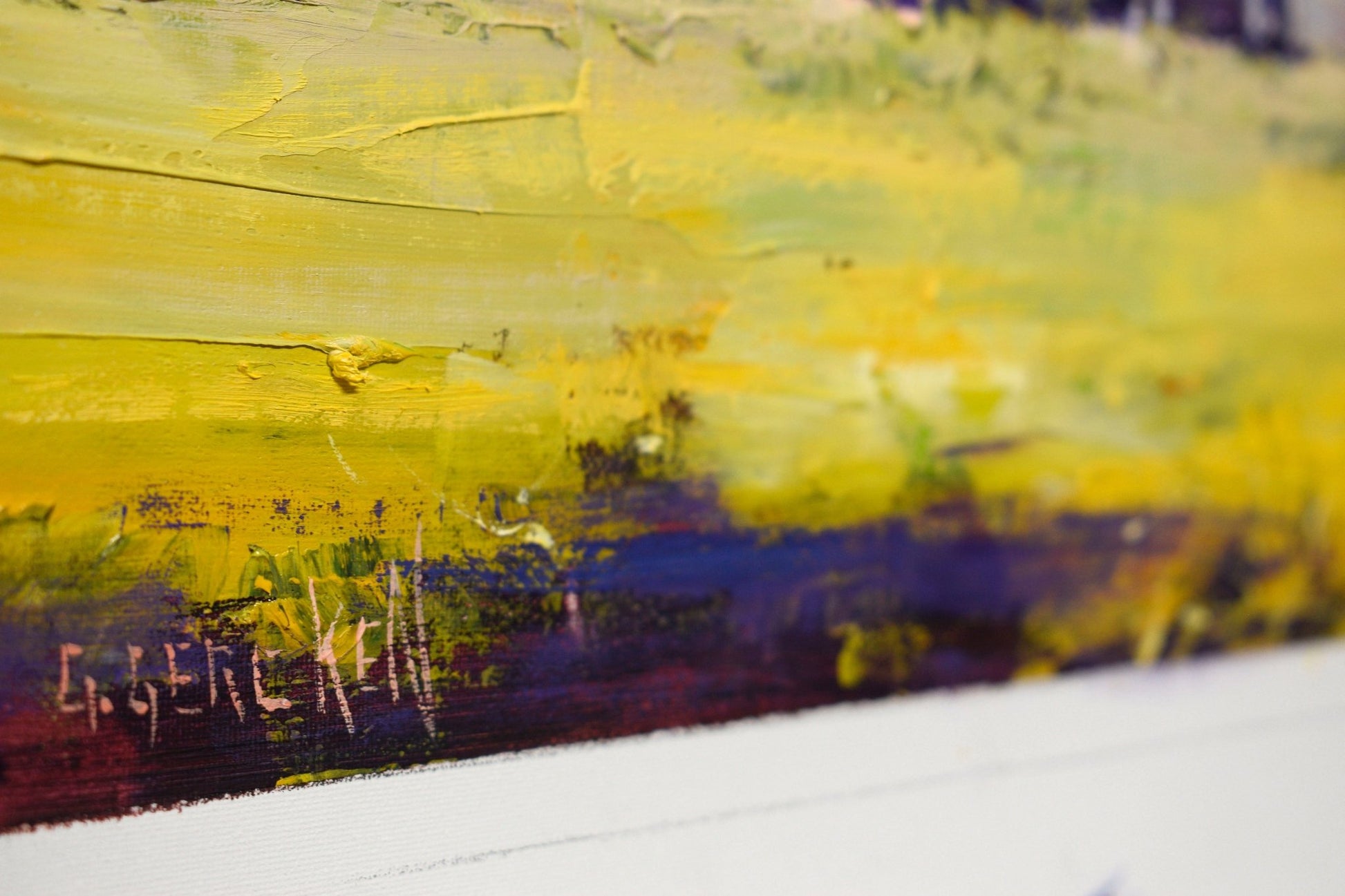 Close-up of a colorful abstract painting with visible signature.