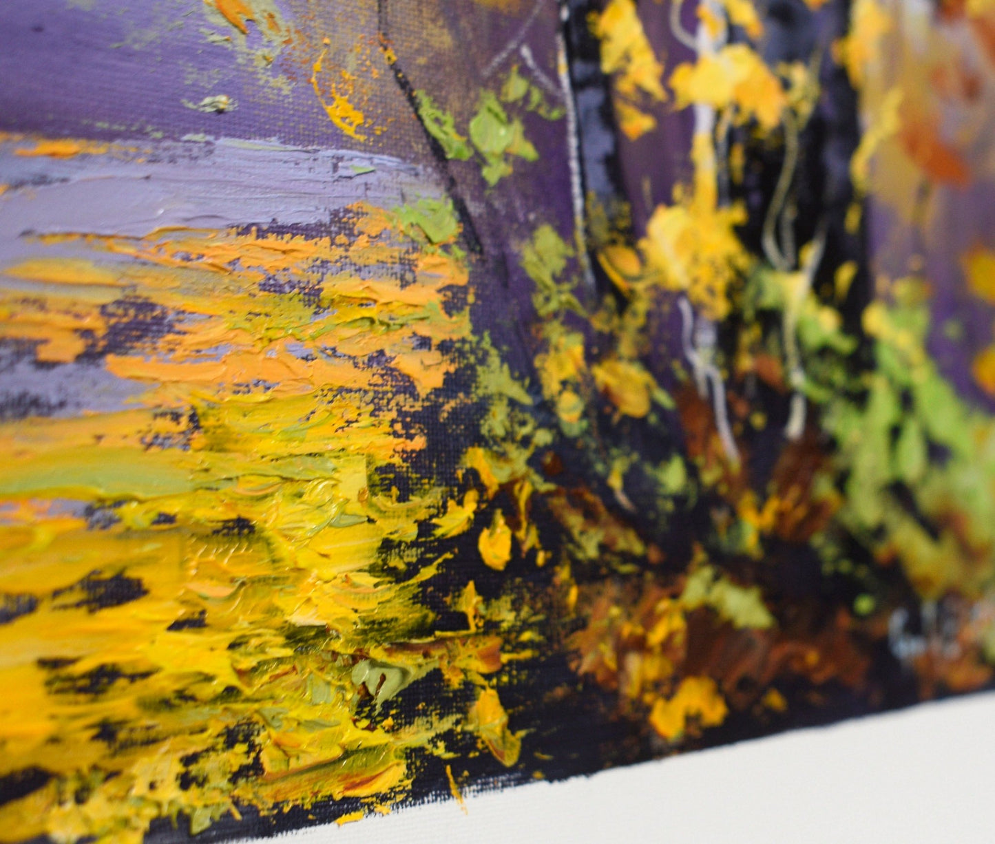 Close-up of a textured surface with yellow, black, and green abstract patterns.